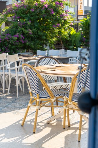 Bistro tables under the bougainvillea