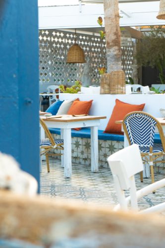 A terrace banquette set for dinner